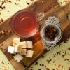 Notendroom (fruit thee) met theezeefje en nougat op houten plank