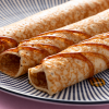 Opgerolde pannenkoeken met dadelsiroop in close-up