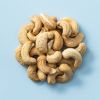 Geroosterde gezouten cashewnoten op een lichtblauwe achtergrond