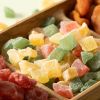 Close-up van rode, gele en groene fruitblokjes op een borrelplank