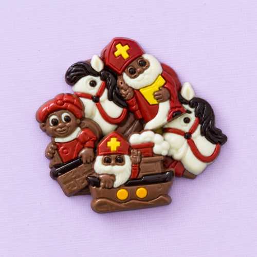 Chocolade Sinterklaasfiguurtjes met Sint, paardjes en bootjes op een lichtpaarse achtergrond Chocolade Sinterklaasfiguurtjes met Sint, paardjes en bootjes op een lichtpaarse achtergrond
